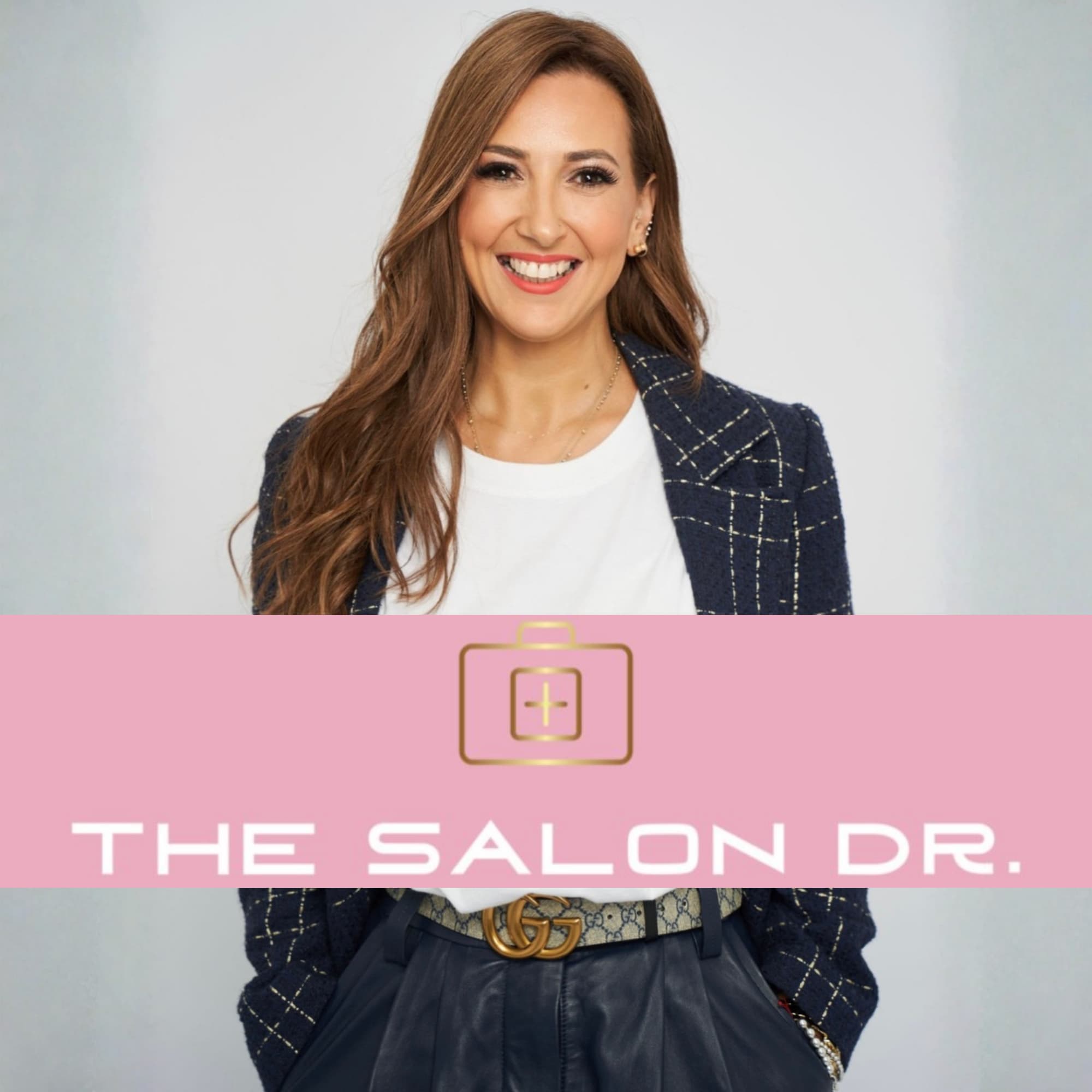 Sonia Tomas, The Salon Dr, standing and smiling in a smart navy blazer—inviting salon owners to build their next level through coaching, strategy, and business development support.